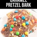A plate of decadent Caramel Pretzel Bark topped with chocolate, colorful candy-coated chocolates, and chopped nuts.