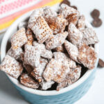 A blue bowl of the chex mix muddy buddies.