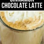 A glass mug filled with rich Cinnamon Chocolate Latte, topped with whipped cream, is shown beneath a label that reads "Cozy Cinnamon Chocolate Latte.
