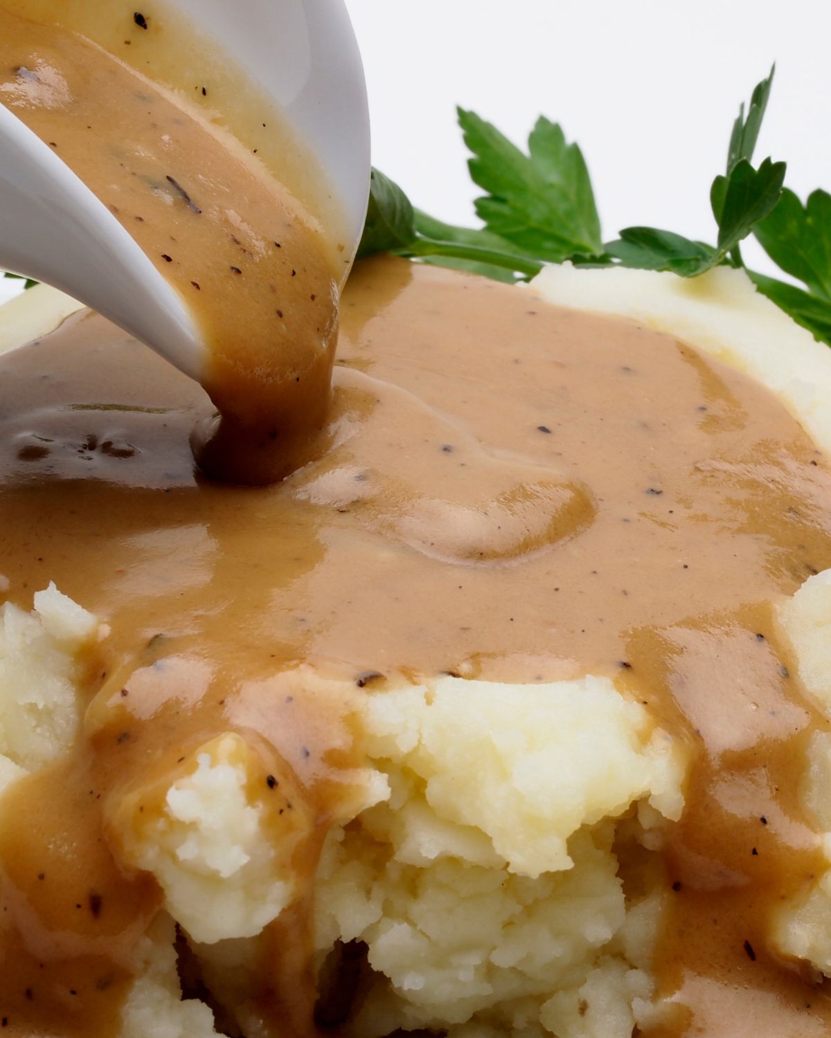 Gravy from drippings over mashed potatoes.