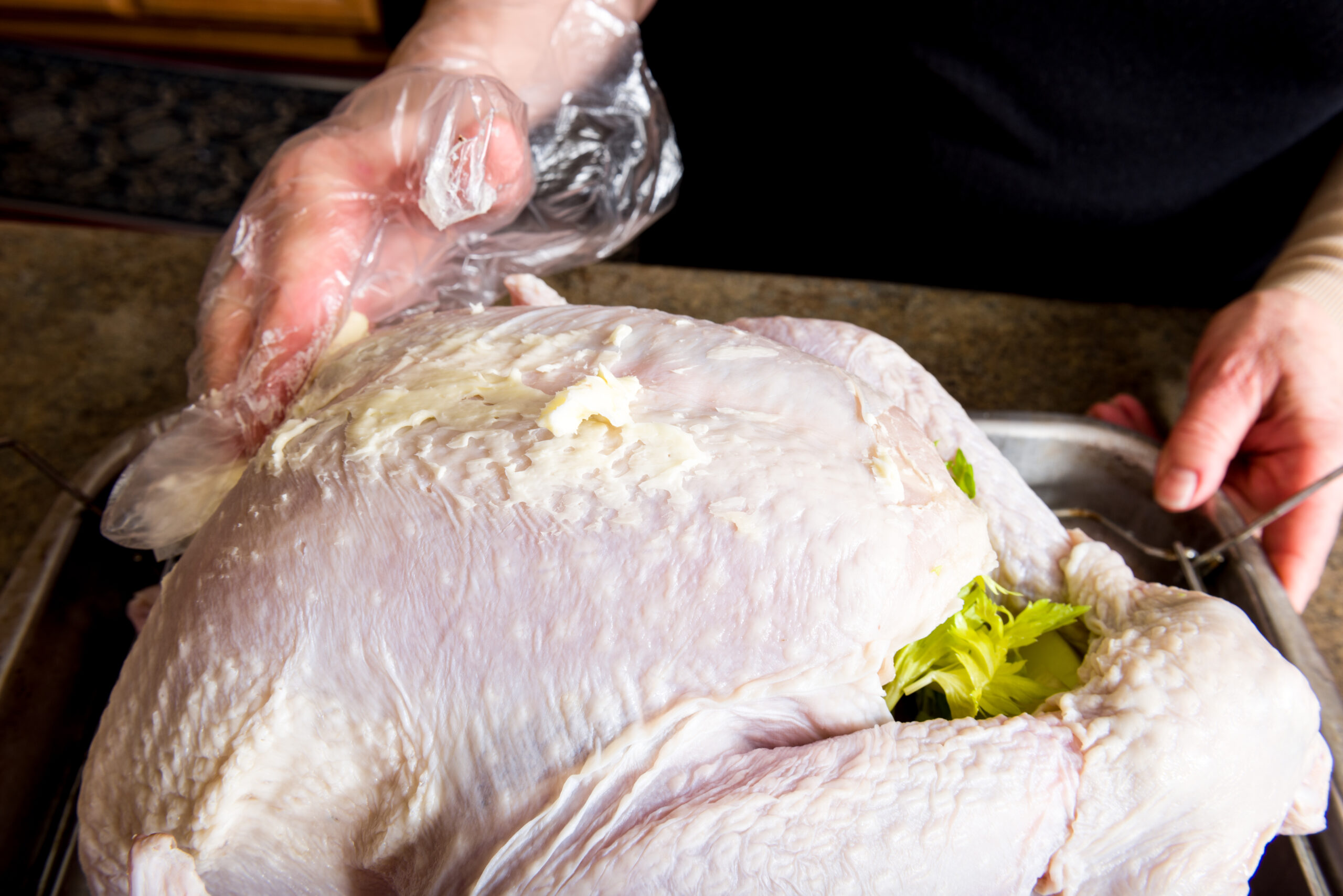 Applying the butter to the convection oven turkey