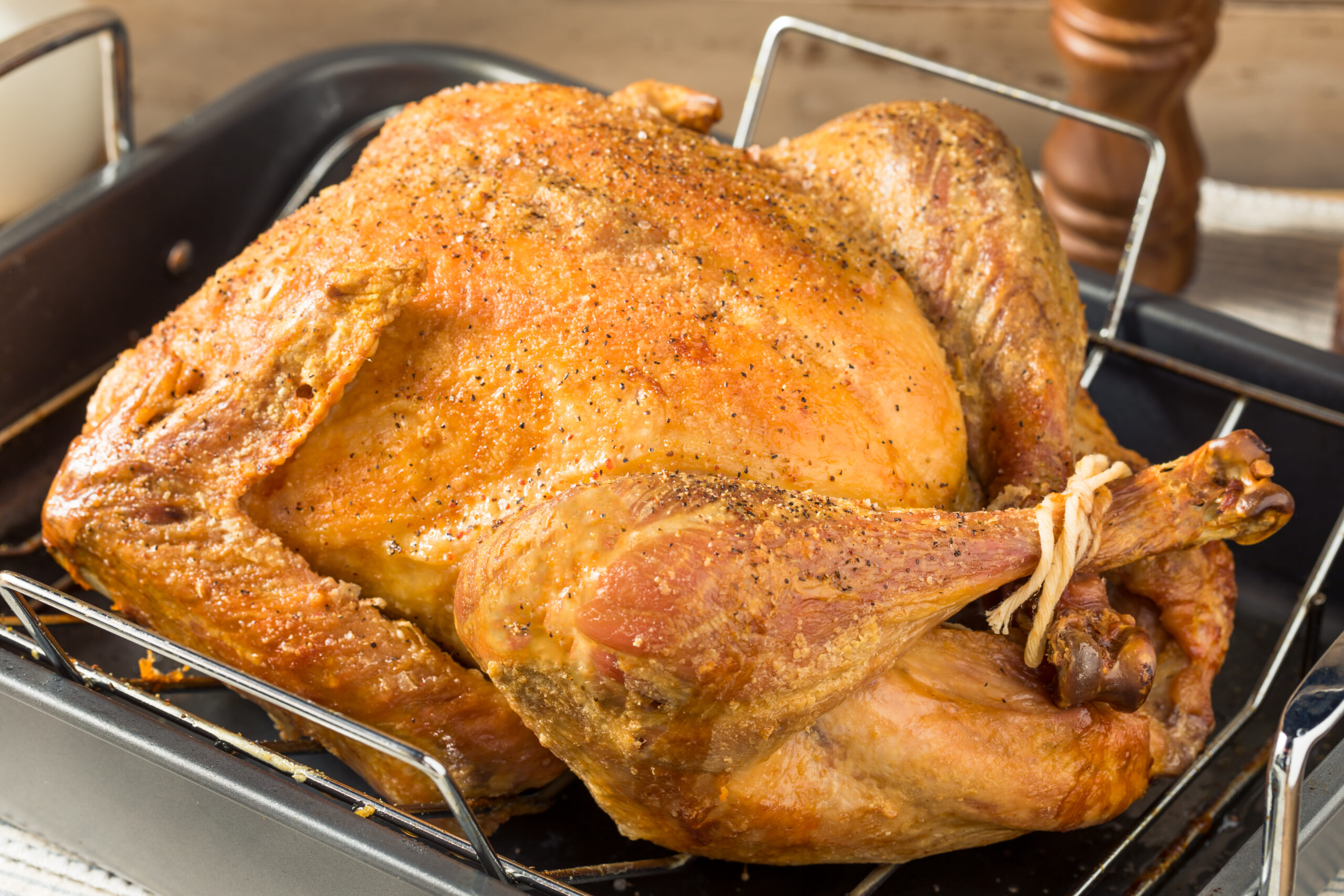 Whole roasted turkey in a roasting pan. 