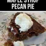 A slice of Maple Syrup Pecan Pie topped with a scoop of vanilla ice cream sits on a floral plate, with a fork holding a bite-sized piece.