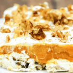 A slice of pumpkin lush on a white plate.