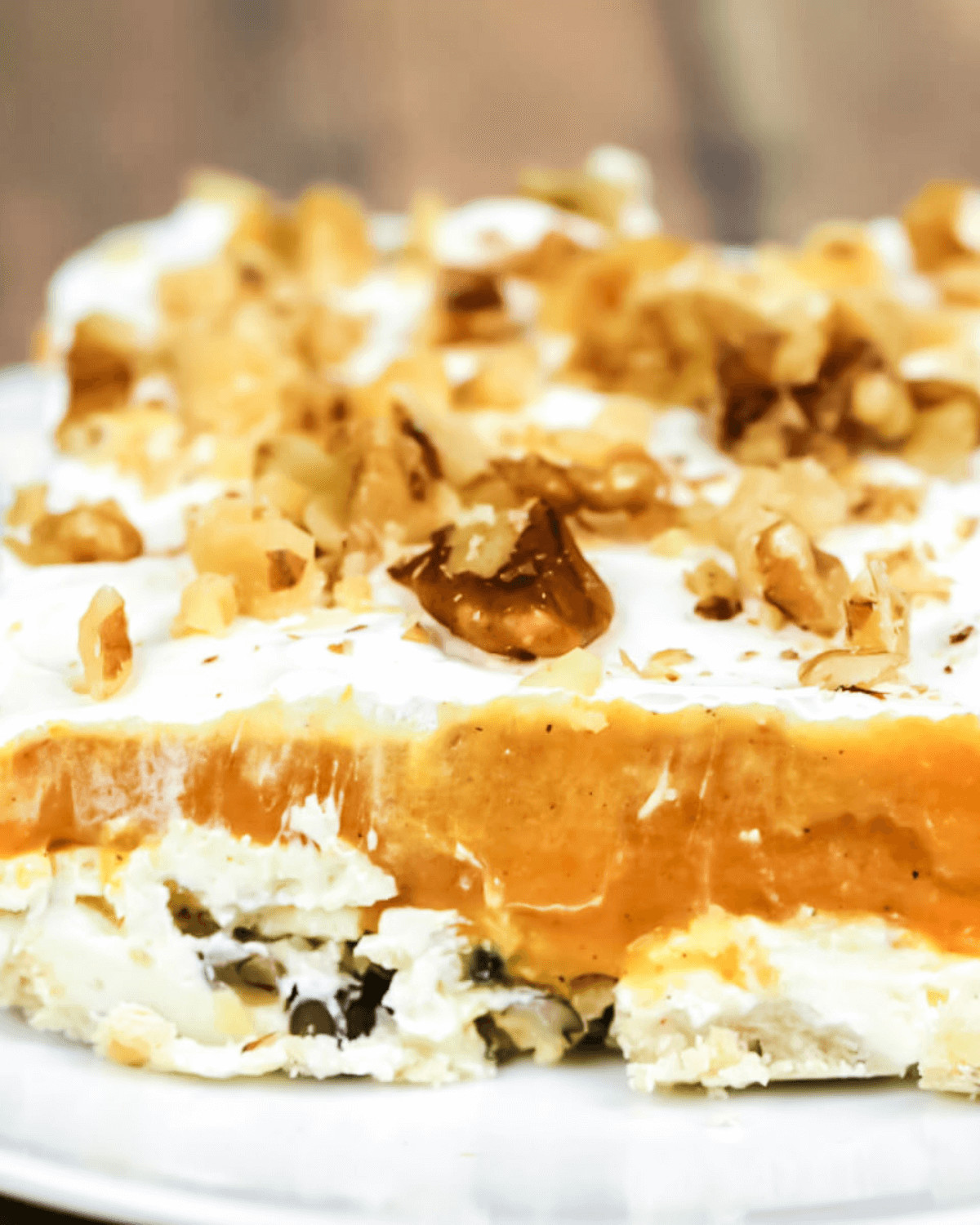 A slice of pumpkin lush on a white plate.