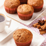 Spice cake pumpkin muffins with coffee on the side.