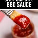 A brush coated with red Chipotle BBQ Sauce hovers above an open jar labeled "Tangy Spicy Chipotle BBQ Sauce.