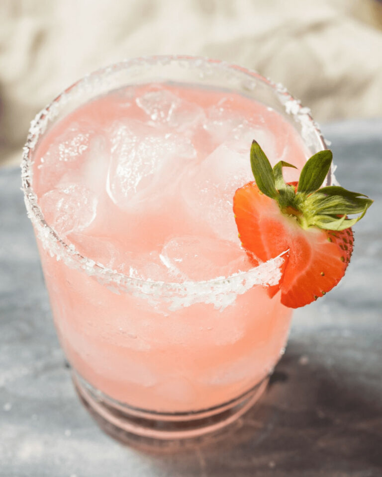 A short glass of the strawberry margarita on the rocks.