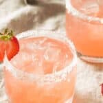 Strawberry margaritas with fresh strawberry on the rim.