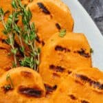 Sweet potato rounds with grill marks.
