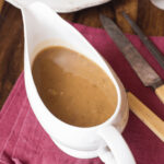 A gravy boat filled with the turkey gravy without the drippings.