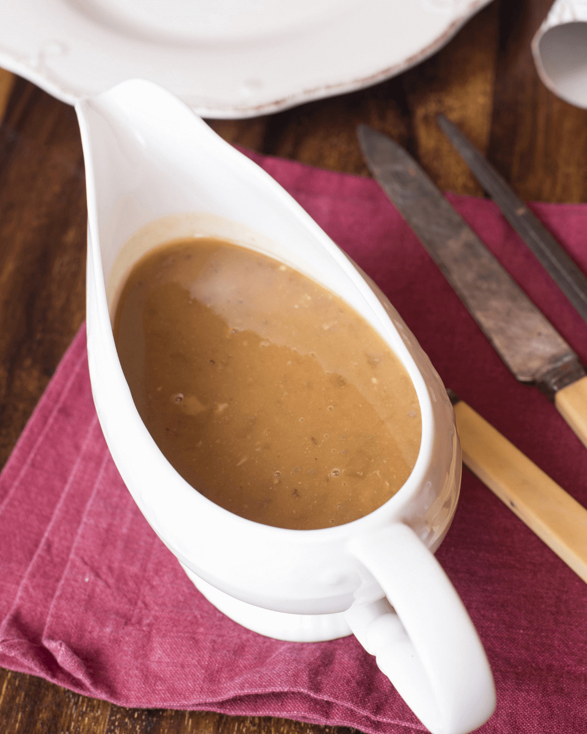 A gravy boat filled with the turkey gravy from drippings.
