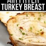 Close-up of cooked, sliced Air Fryer Turkey Breast garnished with herbs on a plate, with text overlay reading "Juicy Air Fryer Turkey Breast.