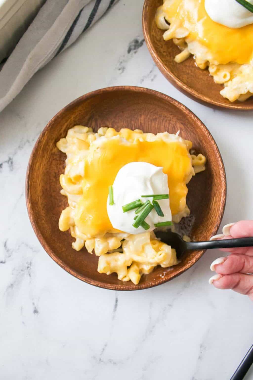 A top shot of the cheesy dinner with cream cheese and fresh herbs on top.