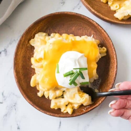 A top shot of the cheesy dinner with cream cheese and fresh herbs on top.