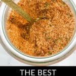 A spoon in a jar filled with a mixture of burger seasoning, with a caption below that reads, "THE BEST BURGER SEASONING.