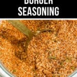 Close-up of a jar filled with coarse burger seasoning, a brass spoon partially submerged in the flavorful mixture. Text at the top reads "The Best Burger Seasoning." Perfect for elevating your grilling game.