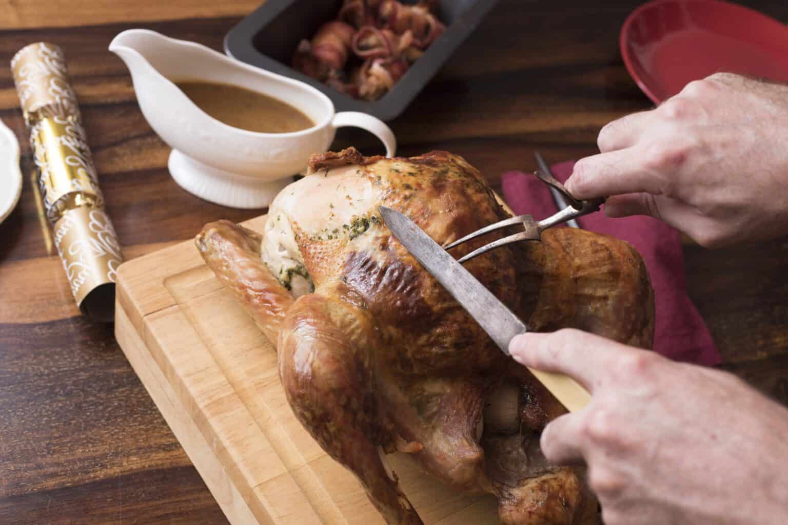 Carving a turkey with knife by the breast bone. 
