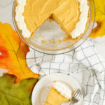 A decorated pumpkin pie with gingersnap crust.