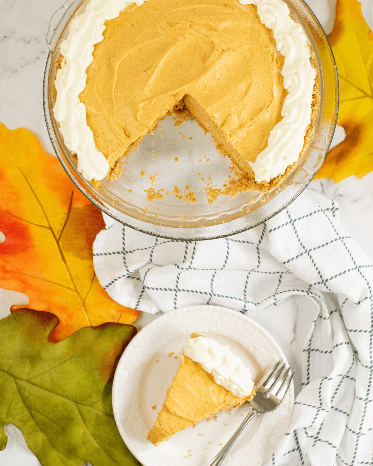 A decorated pumpkin pie with gingersnap crust.