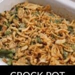 A white dish filled with Crock Pot Green Bean Casserole, topped with crispy fried onions and labeled "Crock Pot Green Bean Casserole" at the bottom.