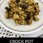 A plate of Crock Pot Stuffing with mushrooms, served on a white plate with a decorative border, sits atop a patterned placemat.