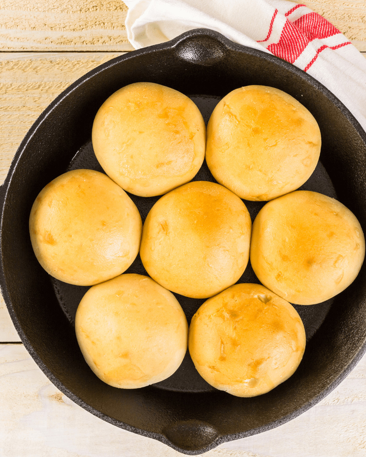 The finished no knead rolls in a cast iron pan.