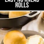 A plate with a whole No Knead Roll and a sliced roll topped with a pat of butter, with a skillet of No Knead Rolls in the background.