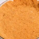 A close-up of a glass pie dish showcases a perfectly pressed Graham Cracker Pie Crust, ready for filling.