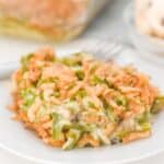 A white plate with green bean casserole without mushroom soup.