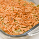 A baking dish with the green bean casserole without mushroom soup.