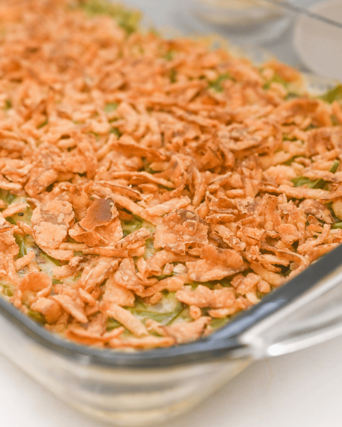 A baking dish with the green bean casserole without mushroom soup.