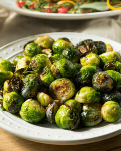 A white plate of Italian Brussel sprouts.