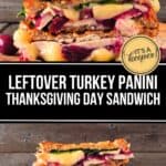 A stacked Turkey Panini sandwich filled with melted cheese, turkey, spinach, and cranberry sauce is displayed on a wooden surface with whole cranberries beside it.