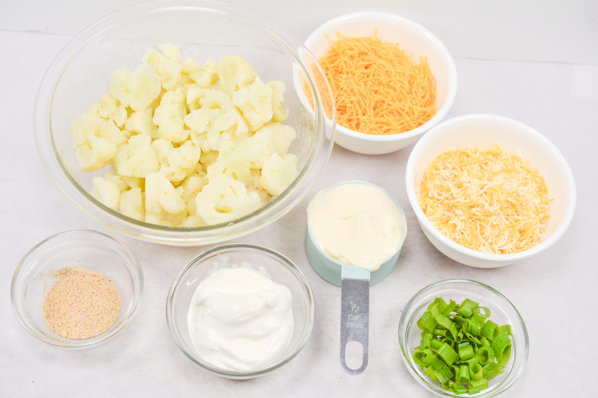 Cheese, cauliflower and other ingredients to make the dish.