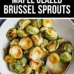 A bowl of Maple Glazed Brussel Sprouts, perfectly roasted and caramelized, with a serving spoon ready to enjoy.