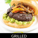 A Mexican Burger featuring a grilled patty topped with creamy avocado, bell peppers, and onions, all served on a freshly toasted bun.