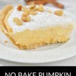 A slice of Pumpkin Cheesecake Pie topped with whipped cream and chopped nuts, served on a white plate.