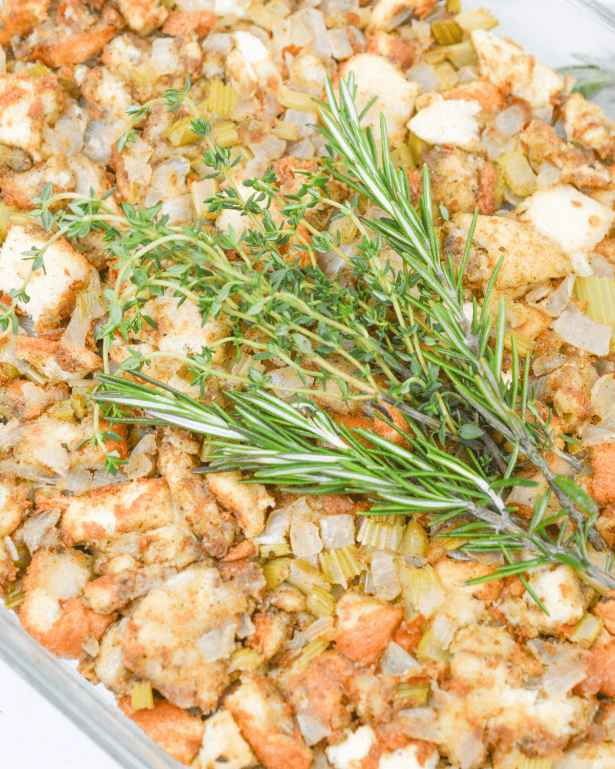 A close up of the sage stuffing with fresh rosemary on top.