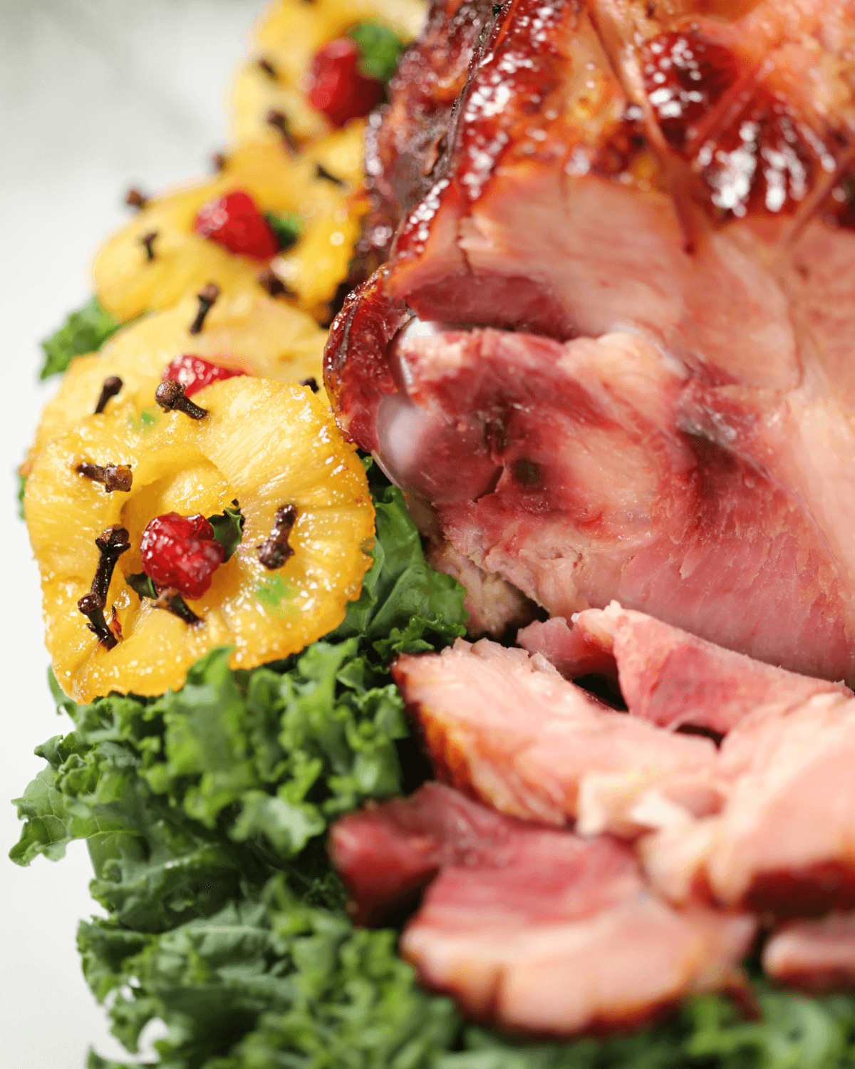 A whole ham studded with pineapple and cherries.