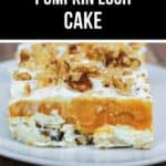 A slice of no-bake Lush Cake, layered with pumpkin and topped with chopped walnuts, sits on a white plate.