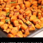 A baking tray filled with Brown Sugar Sweet Potatoes, cut into cubes, roasted to perfection, and sprinkled with fresh herbs, labeled "Roasted Brown Sugar Sweet Potatoes.
