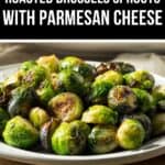 A plate of Roasted Brussels Sprouts with Parmesan Cheese is shown on a white dish, featuring tender sprouts topped with perfectly browned, savory cheese.