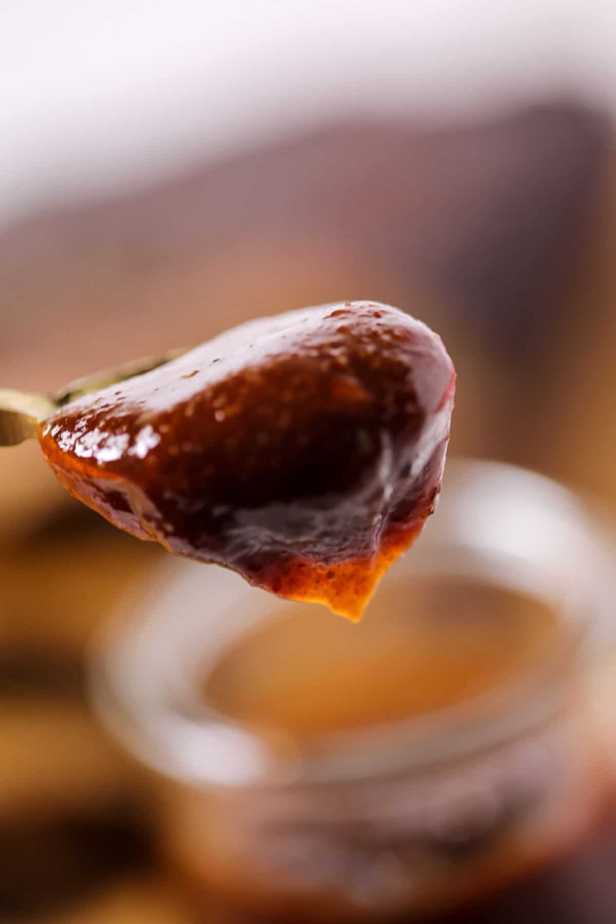 A close up of the spoon holding the sauce.