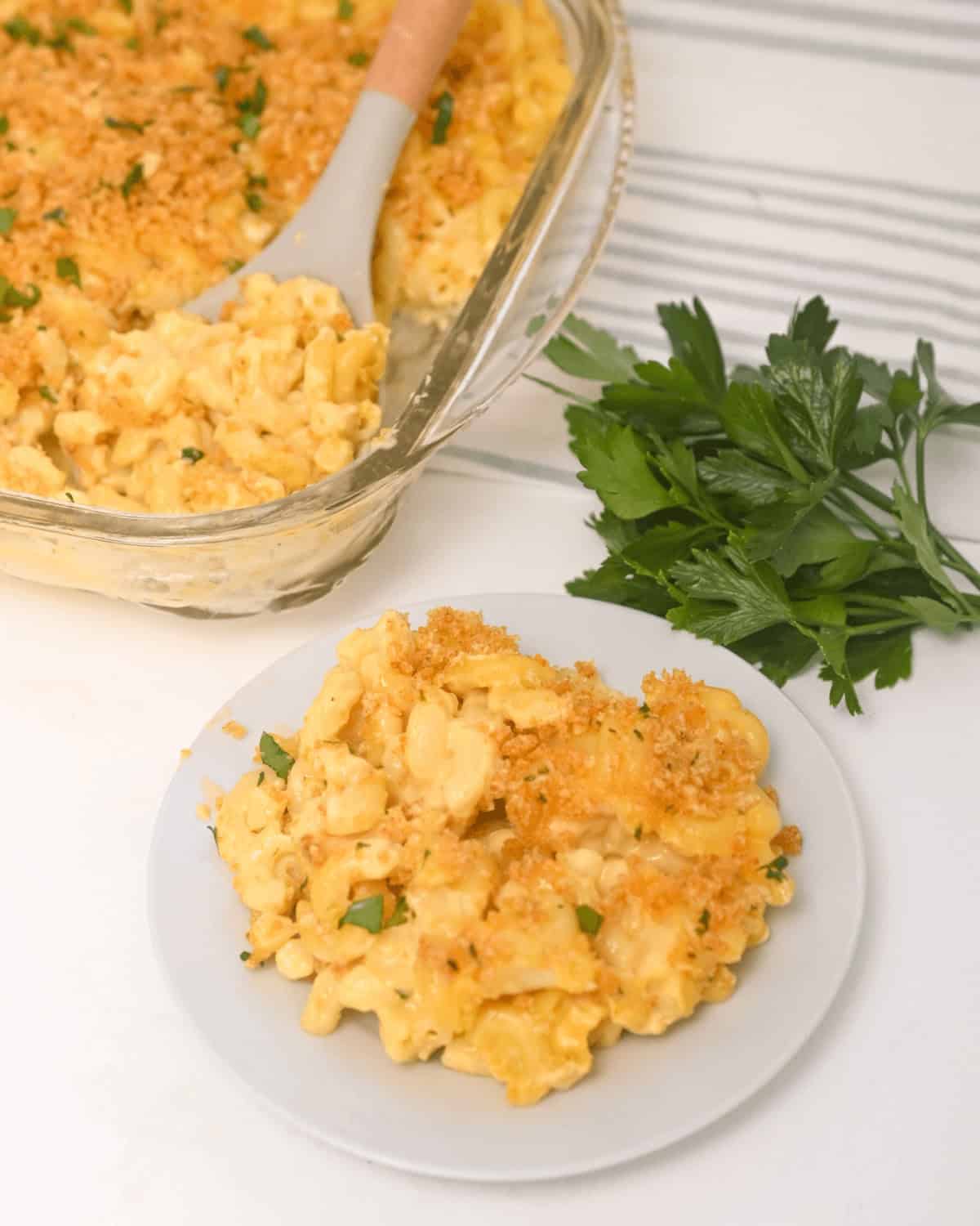 A plate and a baking dish of the velveeta mac & Cheese.