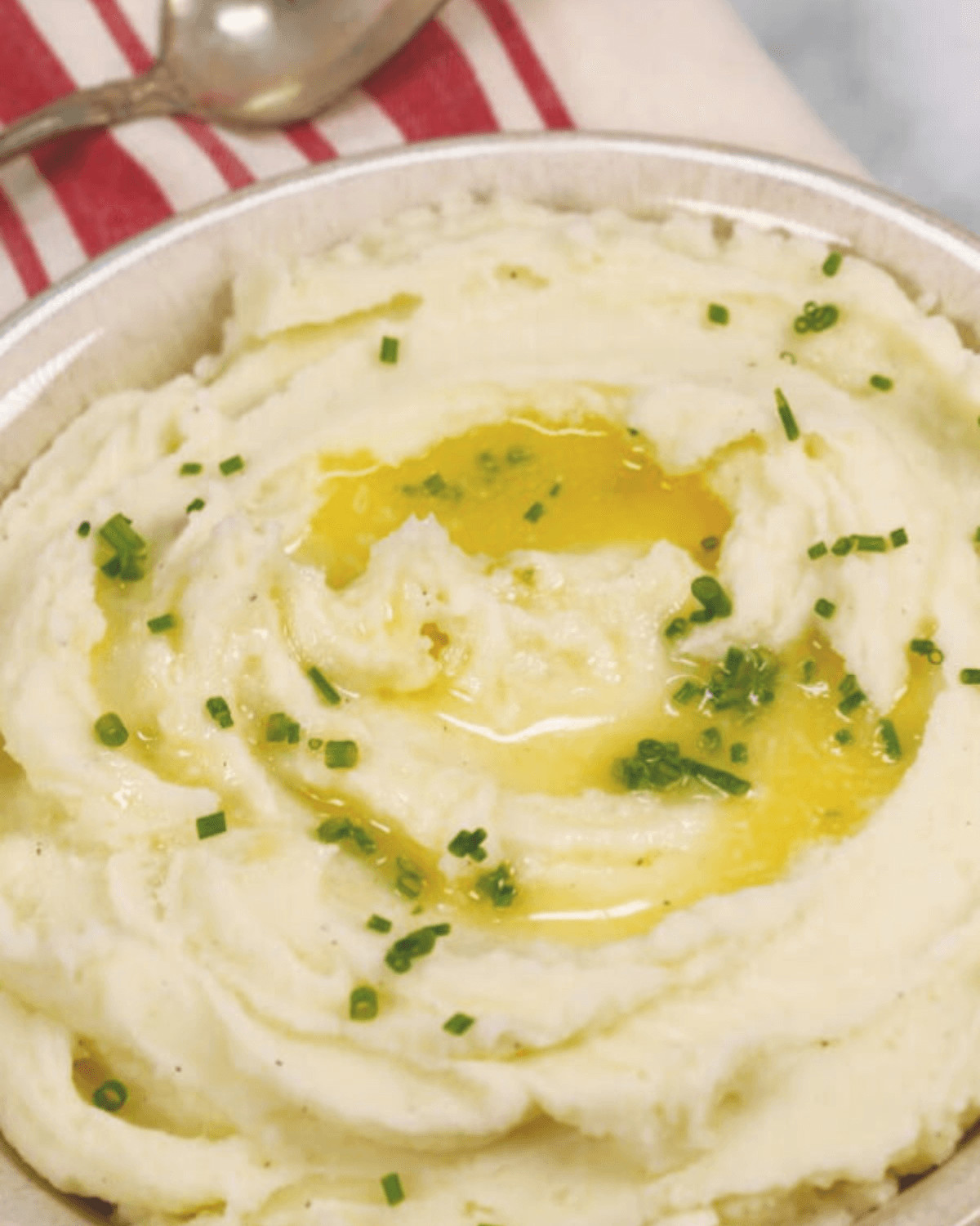 A bowl filled with whipped mashed potatoes.