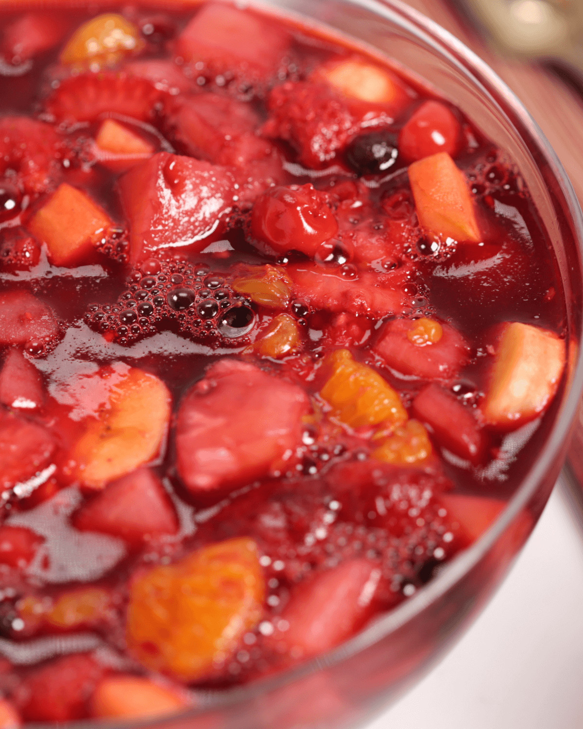 A large bowl of the cherry jello salad with fruit.