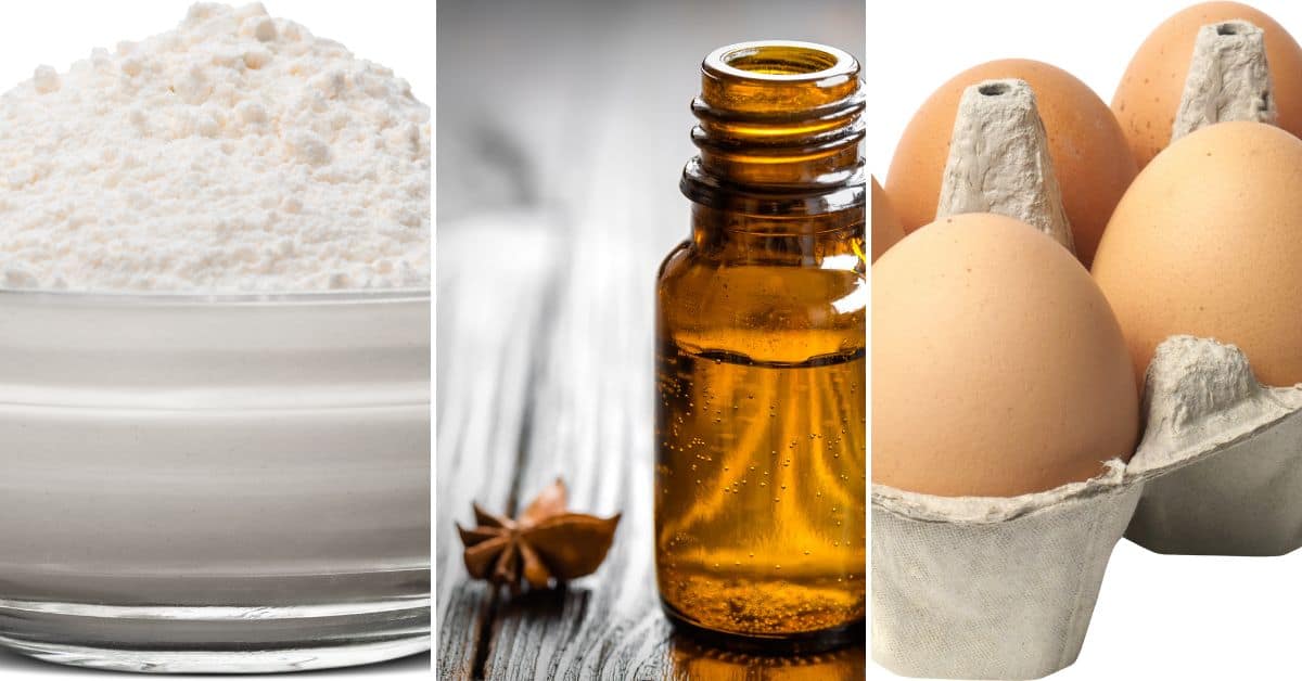 A glass bowl of flour, a small amber bottle with liquid, and a carton holding four brown eggs.