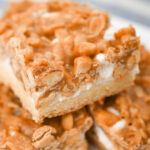Crunchy Peanut Butter Bars stacked on a dish.
