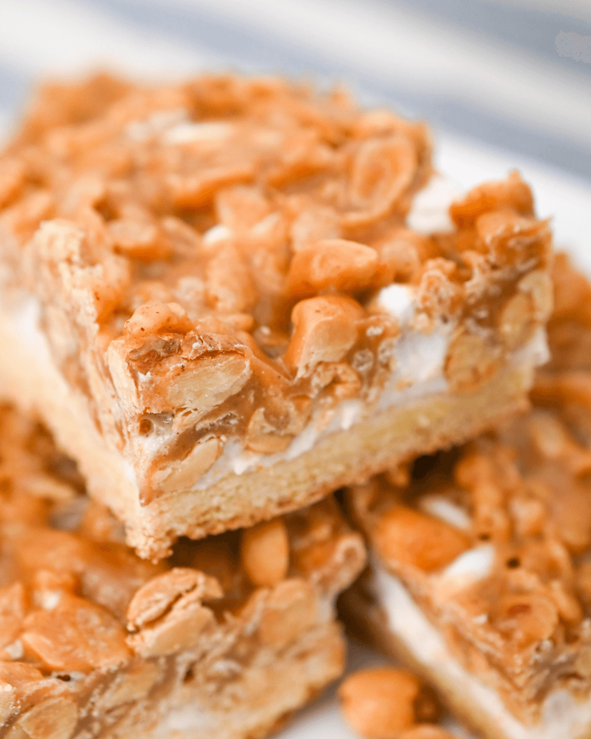 Crunchy Peanut Butter Bars stacked on a dish.